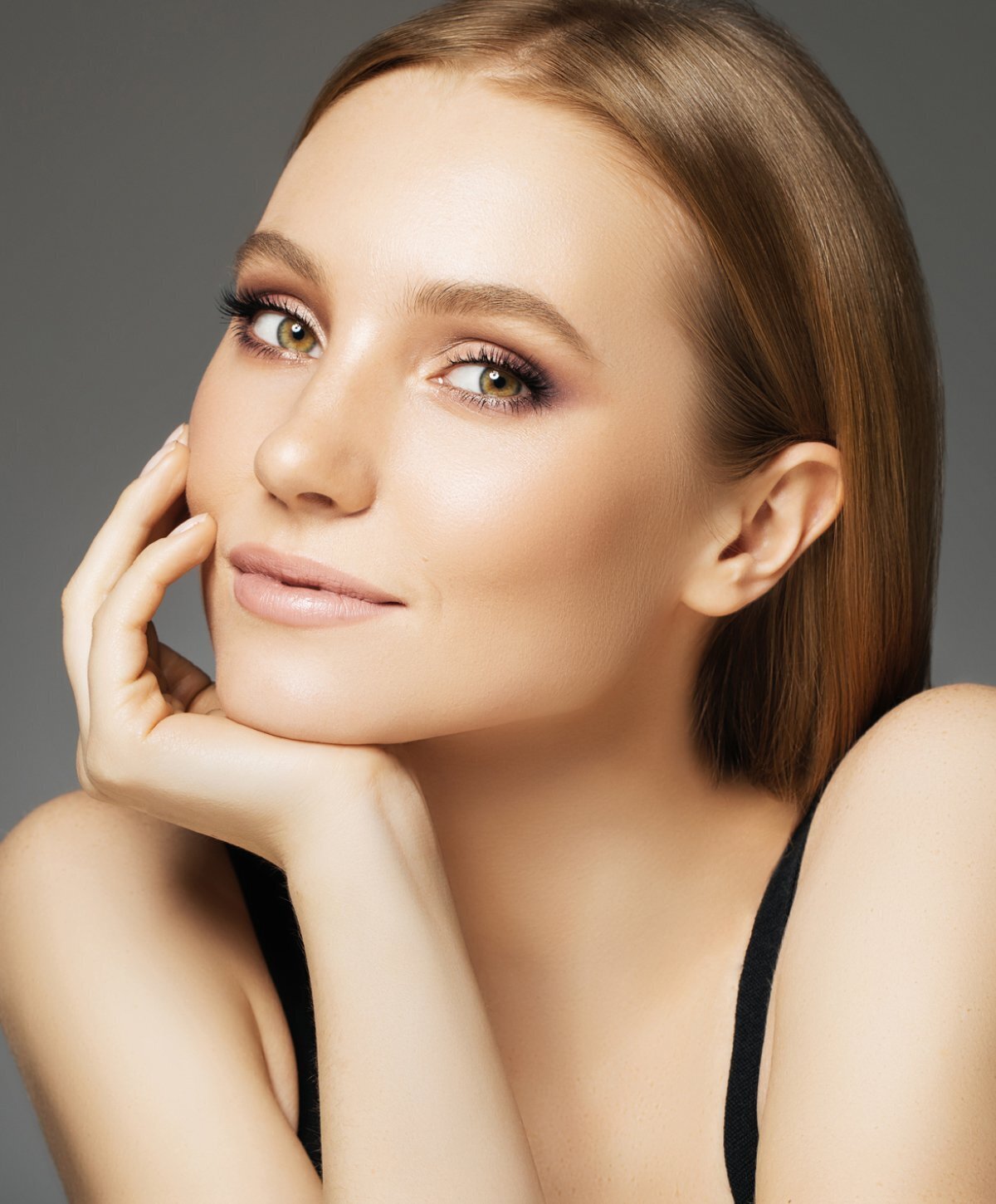 Grand Rapids rhinoplasty patient model resting her chin on her hand