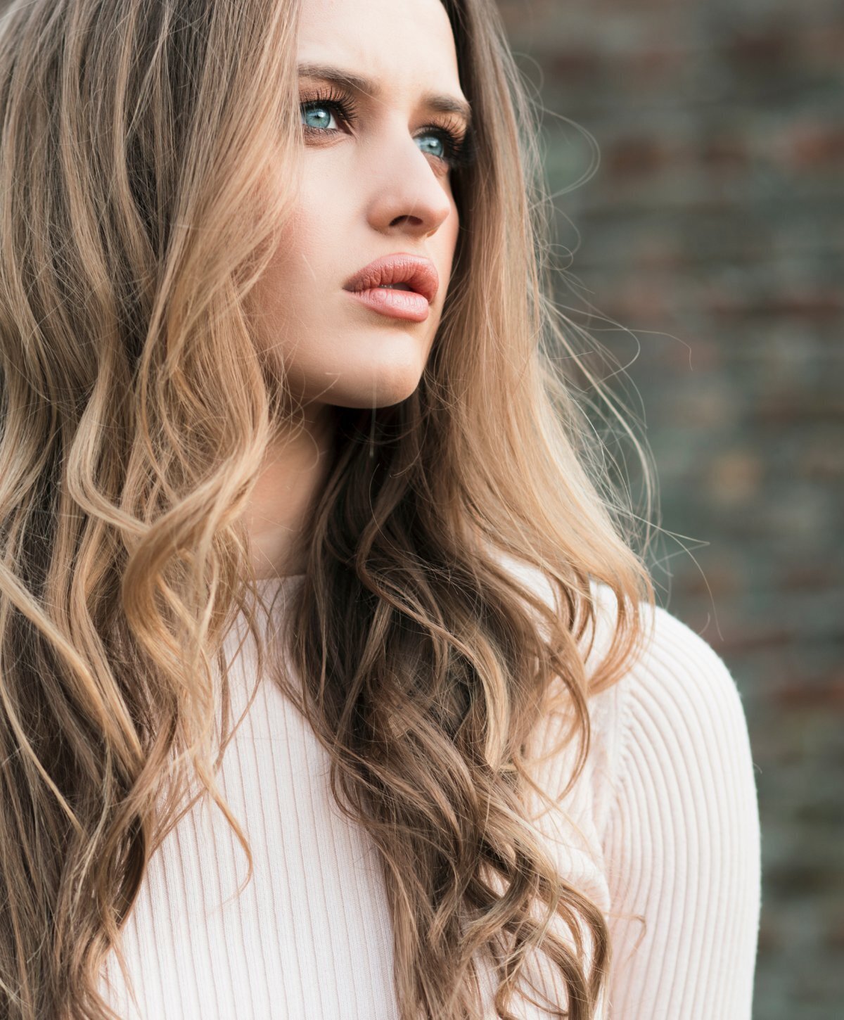 Grand Rapids rhinoplasty patient model with wavy brown hair